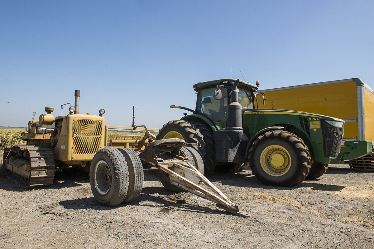 Old versus new. The evolution of farm equipment has allowed farmers to work more efficiently. Here is one of the first tractors used on Schreiner Farms and one of their newest that uses GPS to help with planting and harvest.